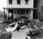 Ruined floor covering is piled outside the home of Cheryl Fryback, 1223 Elm St., after friends and relatives pitched in to help clean her kitchen on Sunday afternoon.