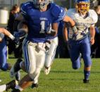 Justin Tranquill runs the ball for Carroll early in the first quarter of Friday night’s game with East Noble. Carroll won, 24-20. (By Ellie Bogue of The News-Sentinel)