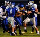 Drue and Justin Tranquill go after ball carrier Lake Clark of East Noble in the second quarter of Friday night’s game with East Noble. Carroll won, 24-20. (By Ellie Bogue of The News-Sentinel)