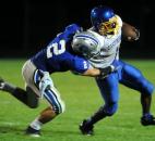 Carroll High School defensive back Drue Tranquill attempts to tackle East Noble running back Brandon Mable on Friday at Carroll. (By Ellie Bogue of The News-Sentinel)