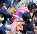 Girls share candy during Aung San Suu Kyi’s address. By Ellie Bogue