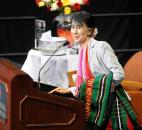 Aung San Suu Kyi gathers her gifts as she bids farewell Tuesday morning after her address and question-and-answer session in front of a crowd of 5,125 at Memorial Coliseum. By Ellie Bogue 