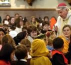 Bishop John D'Arcy, right, talks with fourth-grade students during an All Saints Mass in 2005 at the Cathedral of the Immaculate Conception. The students were dressed as their favorite saints. News-Sentinel file photo