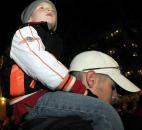 Maclain Baker, 5, watches the newly lit Santa and his reindeer display. He was on the shoulders of his dad, Bob. The family is from Ossian and make it a point to come every year. Photo by Ellie Bogue