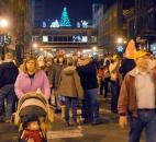 After the Santa and reindeer display was lit the crowd moved down the street for the lighting of the Wells Fargo holiday display and Indiana Michigan Power Merry Christmas wreath at Wayne and Calhoun streets. Photo by Ellie Bogue