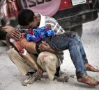 A Syrian man cries while holding the body of his son killed by the Syrian Army in Aleppo, Syria, this October. The country was wracked by civil war throughout the year, with no end in sight, as rebels tried to topple President Bashar Assad. Photo by The Associated Press