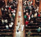 Bishop John D'Arcy, bottom center, walks down the main aisle of the Cathedral of Immaculate Conception to begin Mass for Mother Teresa in September 1997. About 300 people gathered for the service. News-Sentinel file photo