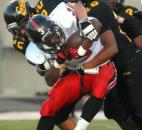 Bishop Luers’ Charles Gaston gets pulled down by Snider’s Jalen McIntosh and Alex Reuille in the the third quarter of Friday night’s home game at Snider with Bishop Luers. Snider won, 10-7. (By Ellie Bogue of The News-Sentinel)