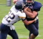 Brad Busse, right, of Bellmont, rushed for 85 yards and two touchdowns in the Braves’ 14-6 win over Norwell on Friday at Bellmont. Norwell’s Andrew Brinson makes the tackle on this first-half run. (Photo by Reggie Hayes of The News-Sentinel)