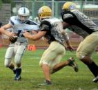 New Haven’s Jakhari Wilbert takes down the Carroll quarterback, Chris Terry. before Terry can throw the ball during the first quarter of Friday night’s game at New Haven. The game was called in the third quarter due to lightening and will resume Saturday at 3 p.m. (Photo by Ellie Bogue of The News-Sentinel)