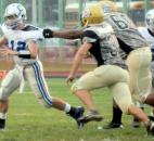 New Haven’s Jakhari Wilbert takes down the Carroll quarterback, Chris Terry. before Terry can throw the ball during the first quarter of Friday night’s game at New Haven. The game was called in the third quarter due to lightening and will resume Saturday at 3 p.m. (Photo by Ellie Bogue of The News-Sentinel)