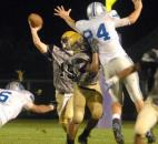 In the third quarter New Haven’s Anthony Moore blocks for Bulldog quarterback Kevin Ware during Friday night’s game at New Haven. The game was called in the third quarter due to lightening and will resume Saturday at 3 p.m. (Photo by Ellie Bogue of The News-Sentinel)