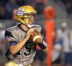 As the rain beats down in the third quarter of play Bulldog quarterback, Kevin Ware, looks for an open receiver to throw to. The game was called in the third quarter due to lightening and will resume Saturday at 3 p.m. (Photo by Ellie Bogue of The News-Sentinel)