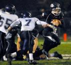Garrett Quarterback Noah Follett runs the ball for some yards during the first quarter of Friday night’s game against Leo. Garrett won 20-6. (By Ellie Bogue of The News-Sentinel)