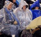 Three ladies try to stay dry Friday night at Garrett High School during the Garrett/ Leo Football game. Garrett beat Leo 20-6. (By Ellie Bogue of The News-Sentinel)