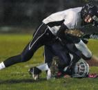 Garrett’s Ryan Vandezande fails catch a pass after being hit by Leo’s Bryce Beer who was trying to intercept the pass Friday when took on Garrett took on Leo. Neither made the catch. Garrett won 20-6. (By Ellie Bogue of The News-Sentinel)