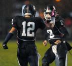 Garrett’s Drake Landes celebrates with teammate Noah Follett after scoring the first touchdown of Friday night’s game. Garrett beat Leo 20-6. (By Ellie Bogue of The News-Sentinel)