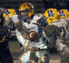 Homestead’s Matt Skowronek fakes a handoff to Grayson Bastin before running the ball on a quarterback keeper during the third quarter. Snider beat Homestead 30-20. (By Ellie Bogue of The News-Sentinel)
