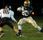 Bishop Dwenger’s D’Marcus Moon gets a few yards in during the second quarter of the game against Columbia City Friday night. About to tackle him is Columbia City’s Justin Bachelder. Bishop Dwenger won the game 36-14 (By Ellie Bogue of The News-Sentinel)