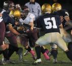 Bishop Dwenger’s defense comes down on Columbia City’s Adam Neely in the first quarter of play against Columbia City Friday night. Bishop Dwenger won the game 36-14 (By Ellie Bogue of The News-Sentinel)
