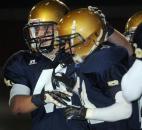 Bishop Dwenger’s Gabriel Espinoza gets congratulated by Jordan Tippman after scoring the third touchdown for Dwenger, in the first quarter, of the game against Columbia City Friday night. Bishop Dwenger won the game 36-14 (By Ellie Bogue of The News-Sentinel)
