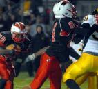 In the third quarter North Side's Anthony Linnear fights for some yardage against Snider. Snider won the game 24-14. Photo by Ellie Bogue of The News-Sentinel