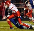 Carroll's Alexander Hammond pulls down Thomas Favorite of South Bend Adams in the second quarter Friday night at Carroll High School. Carroll won 44-35. Photo by Ellie Bogue of The News-Sentinel