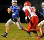 Carroll's Christian Terry looks for someone to pass to during the second quarter against South Bend Adams Friday night at Carroll High School. Carroll won 44-35. Photo by Ellie Bogue of The News-Sentinel