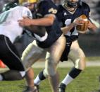 Bishop Dwenger's Cody Miller looks for someone to pas to   in the first quarter of the game against Concord Friday night . Photo by Ellie Bogue