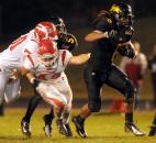 Snider's Nicolas Reese runs the ball in the third quarter of Friday night 's game against Fishers. Snider won the  game in overtime by a two point conversion. Photo by Ellie Bogue
