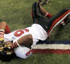 Bishop Luers' Jaylon Smith falls to the ground in a happy moment after the team won the Class 2A IHSAA football championship game Friday night at Lucas Oil Stadium in Indianapolis. Photo by Ellie Bogue