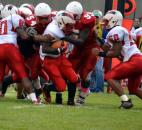 North Side running back Anthony Linnear is gang tackled by Wayne’s JocQuaylin Thomas, No. 95, and DaQuan Coates, No. 54. (Photo by Blake Sebring of The News-Sentinel)