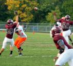 Concordia Lutheran’s Brandon Webb, left, reaches up just before he blocks a pass attempt by Northrop quarterback Colin Brockhouse who was being rushed by Marquis Alexander. (By Don Converset of The News-Sentinel)