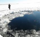 A circular hole in the ice of Russia's Chebarkul Lake where a meteorite reportedly struck Friday.