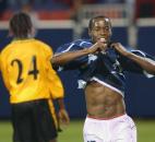 United States midfielder DaMarcus Beasley celebrates scoring late in the second half against Jamaica during a friendly match Thursday, May 16, 2002 in East Rutherford, N.J. At left is Jamaica defender Robert Scarlet. The United States won 5-0. 