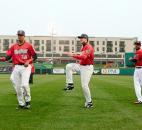TinCaps players stretch and warm up before what would prove to be a wet and chilly evening. (Photo by Gannon Burgett for The News-Sentinel)