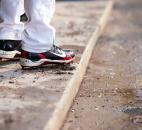 A TinCaps player stands in the dugout Thursday with water and sunflower seeds around his cleats. (By Gannon Burgett for The News-Sentinel)