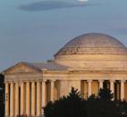 A full moon rises behind the Jefferson Memorial in Washington on Saturday.