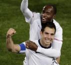 United States' Carlos Bocanegra, front, and United States' DaMarcus Beasley, top, celebrate following the World Cup group C soccer match between the United States and Algeria at the Loftus Versfeld Stadium in Pretoria, South Africa, Wednesday, June 23, 2010.