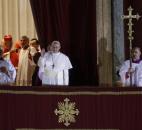 Pope Francis, flanked by Monsignor Guido Marini, master of liturgical ceremonies, waves to the crowd Wednesday from the central balcony of St. Peter's Basilica at the Vatican. (Photo by The Associated Press)