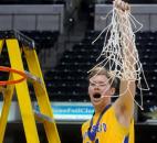 Homestead's Dana Batt holds up the net after cutting it down Saturday night at Bankers Life Fieldhouse. Homestead won the Class 4A IHSAA Boys Basketball Final, 91-90, in a hard fought game.