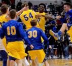 The Homestead Boys Basketball team celebrates after they beat Evansville Reitz Panthers 91-90 in overtime Saturday night in Indianapolis to win the IHSAA  Class 4A Boys Basketball championship.