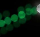 A full moon rises through a hazy sky past a string of green lights Saturday in Baltimore. 