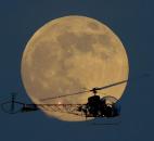 A full moon rises Saturday behind the helicopter from the original Batman television show, which people can ride at the New Jersey State Fair, in East Rutherford, N.J.   A full moon rises Saturday behind the helicopter from the original Batman television show, which people can ride at the New Jersey State Fair, in East Rutherford, N.J.