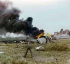 In this April 4, 1975 file photo, smoke rises from the wreckage of a U.S. Air Force C-5A transport plane after it crashed in a paddy field shortly after takeoff from the Saigon Airport, killing a large number of orphan children who were on board in a rescue flight from South Vietnam. (AP Photo/Dang Van Phuoc, File)