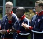 U.S. World Cup soccer team midfielder DaMarcus Beasley, center, waves while flanked by midfielder Michael Bradley, left, and defender Jonathan Spector as the U.S. World Cup roster is announced at the ESPN studios in Bristol, Conn., Wednesday, May 26, 2010. 