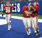 Adams Central players celebrate in the end zone during the 2000 Class A state finals at the RCA Dome in Indianapolis. Adams Central beat previously undefeated Attica 29-21 in the championship game to finish the season 12-3 and win the school's first and only football state championship. (News-Sentinel file photo)