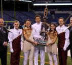 Concordia Lutheran Marching Cadets leaders accept their Class C state runner-up trophy Saturday in Indianapolis. The students are drum major Bradley Murphy, color guard co-captain Allyson Pasche, senior drum major Jonathan NaThalang, color guard co-captain Brittany Anderson and drum major Michaela Holloway. ISSMA President-Elect Tim Johnston of Scottsburg is at left. Photo by Garth Snow