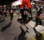 Bishop Luers’ Marc Cotter, center, and the Knights run out to the field before the start of the second half of their homecoming game against North Side on Friday at Luersfield. (By Chad Ryan of INMedia Source)