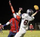 Garrett receiver Ryan Vandezande, right, attempts a one-handed grab as Heritage defensive back Zach Toles tries to break up the play during Friday's game at Heritage. Photo by Chad Ryan